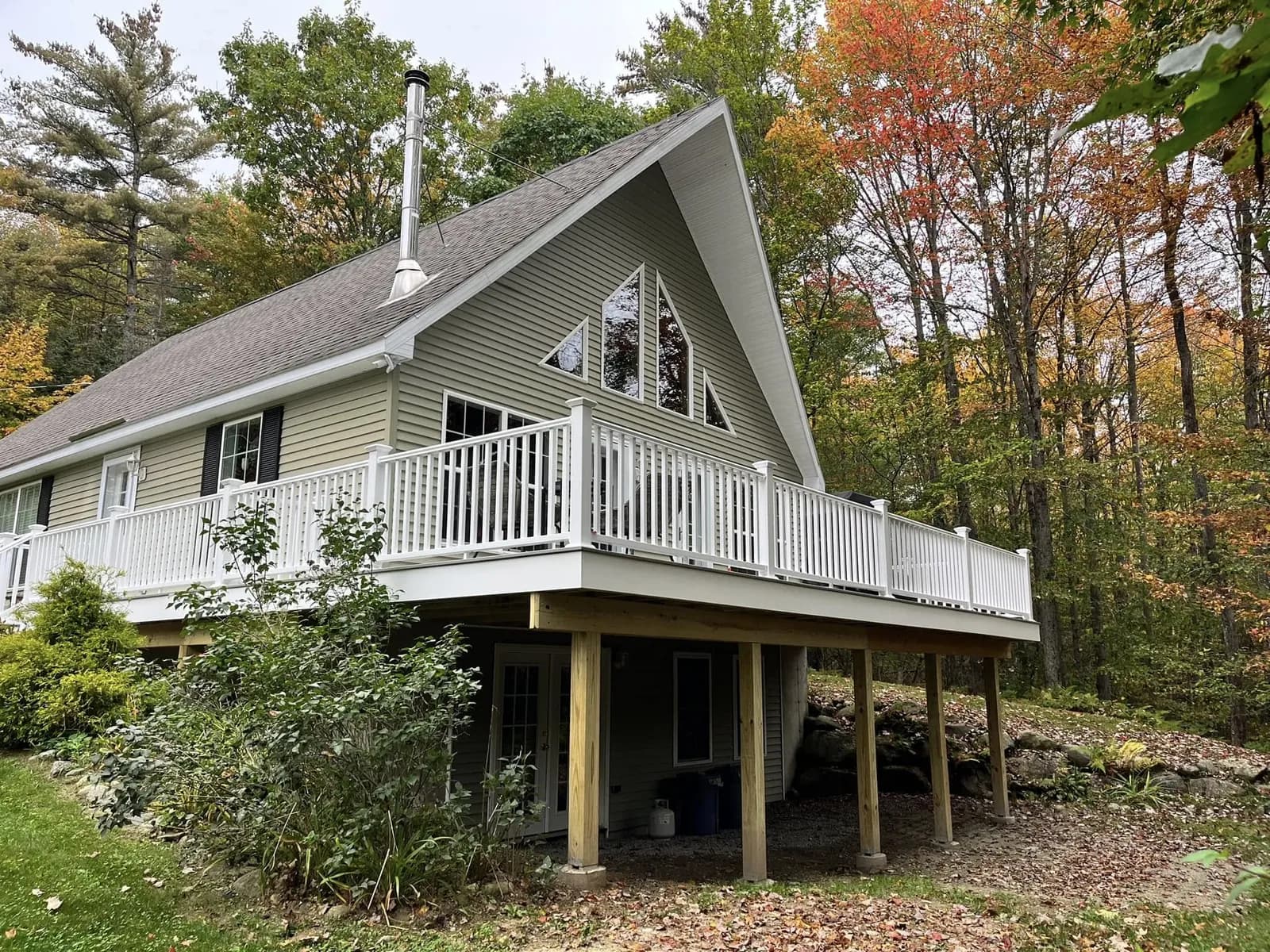 Chalet deck with white railing — Decks project in Lakes Region, NH by A&E Home Improvement