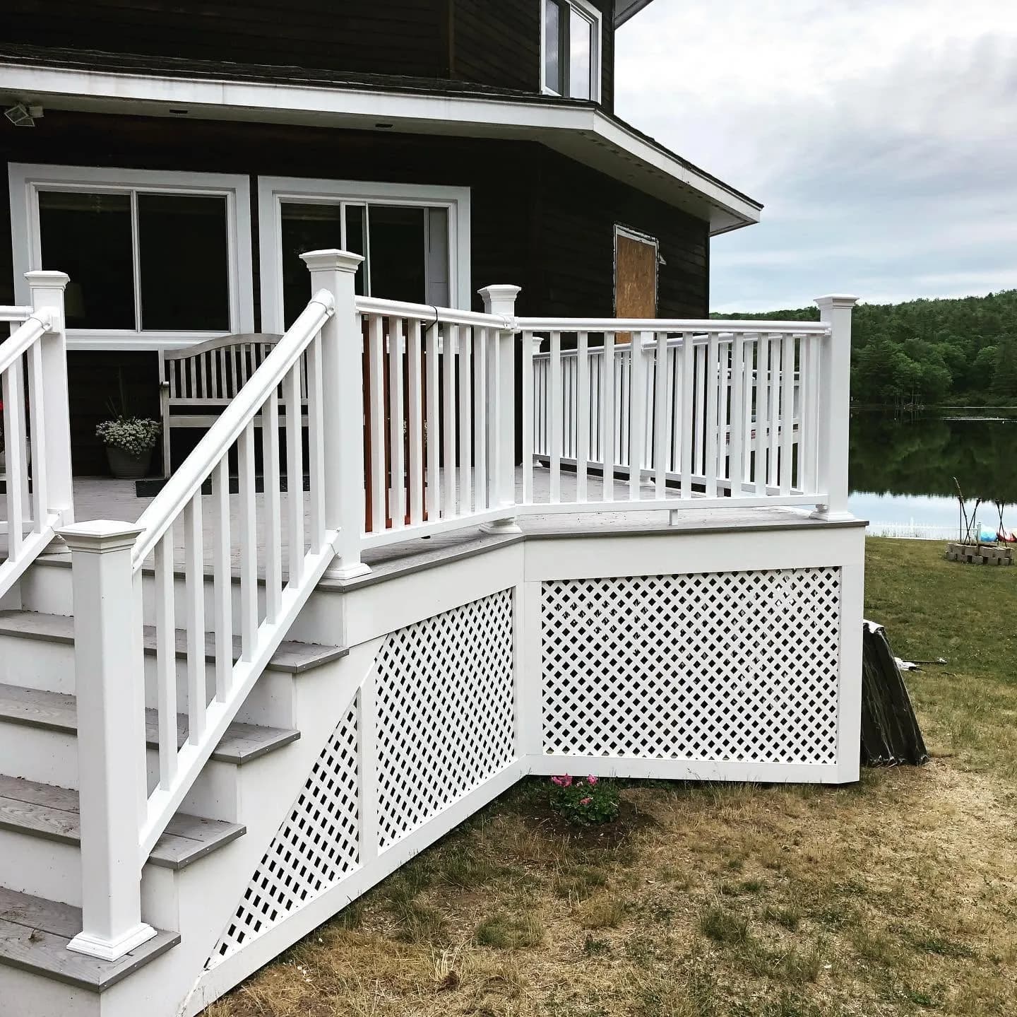 Lakeside deck with white railing and lattice skirt — Decks project in Lakes Region, NH by A&E Home Improvement