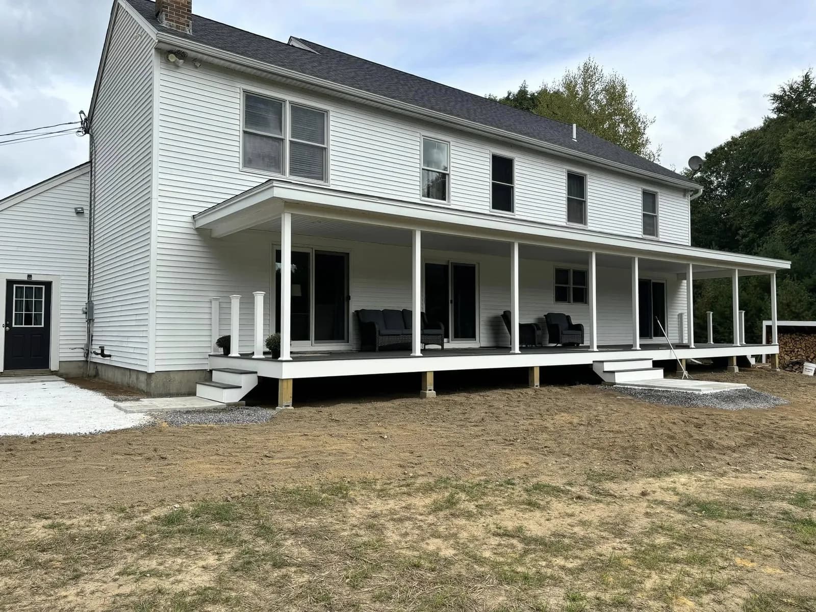 Farmhouse with covered wraparound porch — Design/Build project in Central NH by A&E Home Improvement