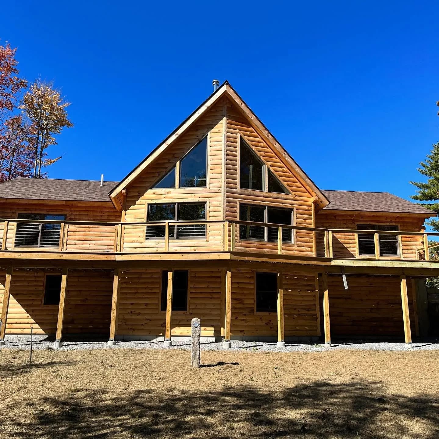 Log home with wraparound deck — Design/Build project in Lakes Region, NH by A&E Home Improvement