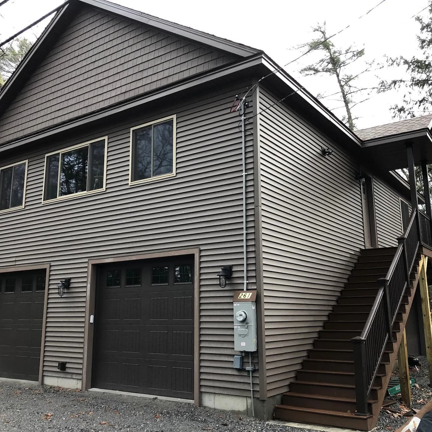 Two-bay garage with living space above — Garages project in Lakes Region, NH by A&E Home Improvement