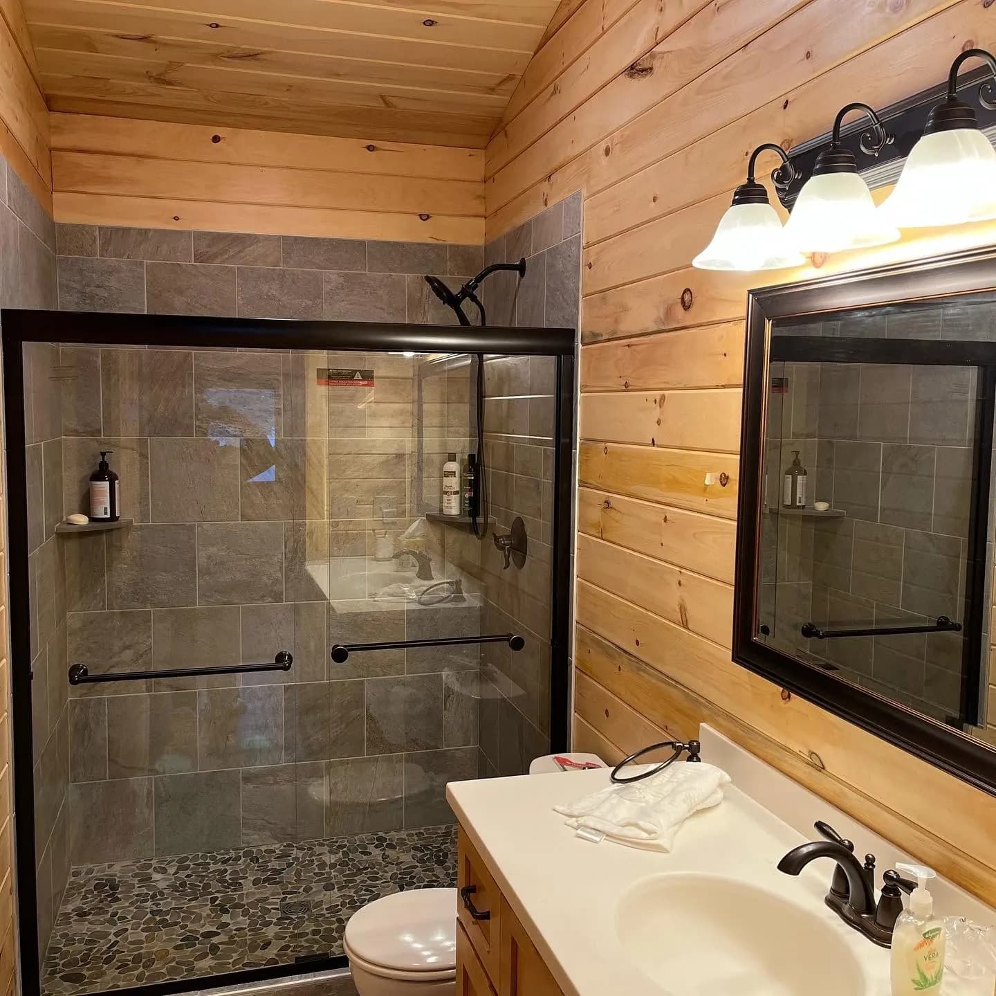 Cabin bathroom with tiled shower — General Contracting project in Lakes Region, NH by A&E Home Improvement