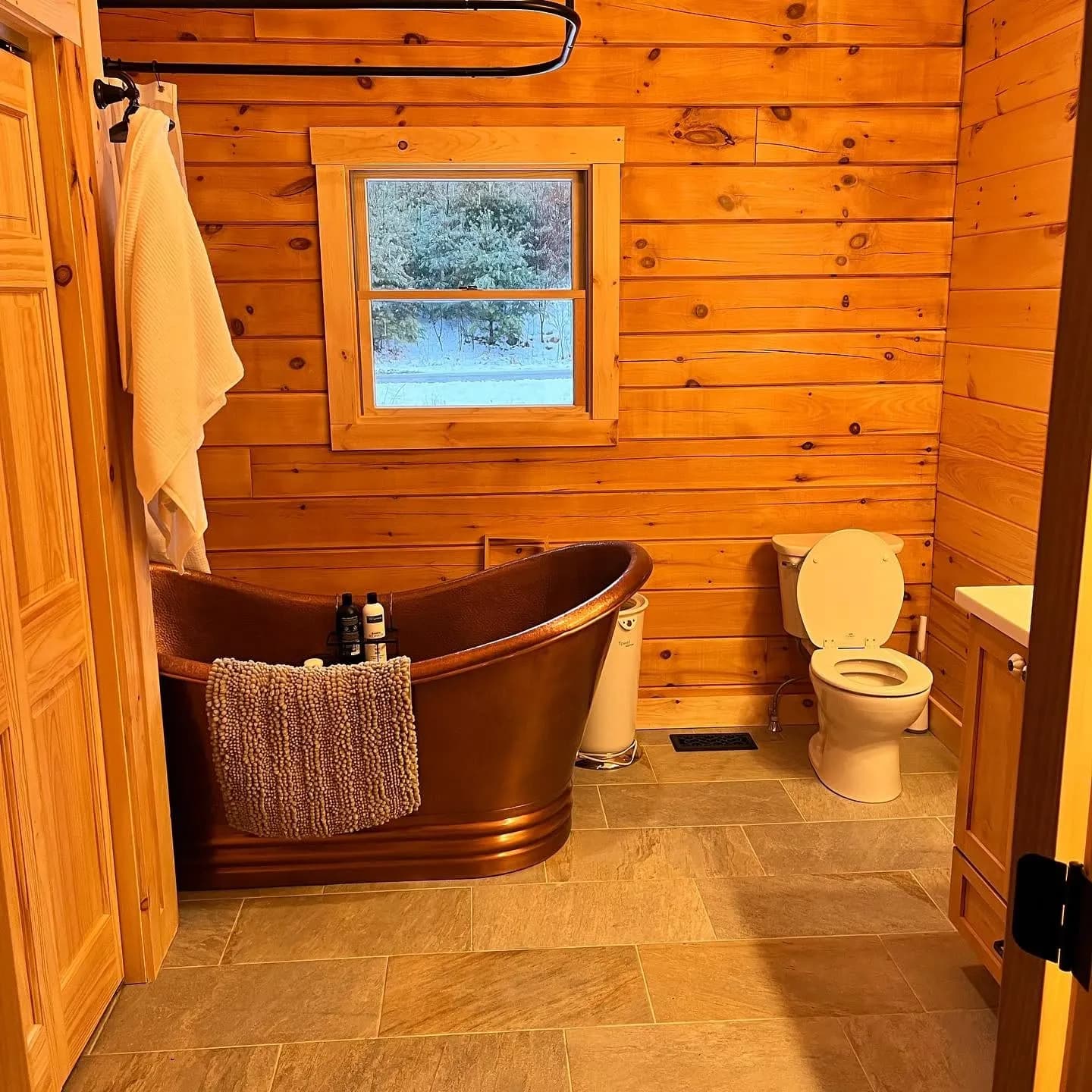 Copper soaking tub in a pine bathroom — General Contracting project in Lakes Region, NH by A&E Home Improvement