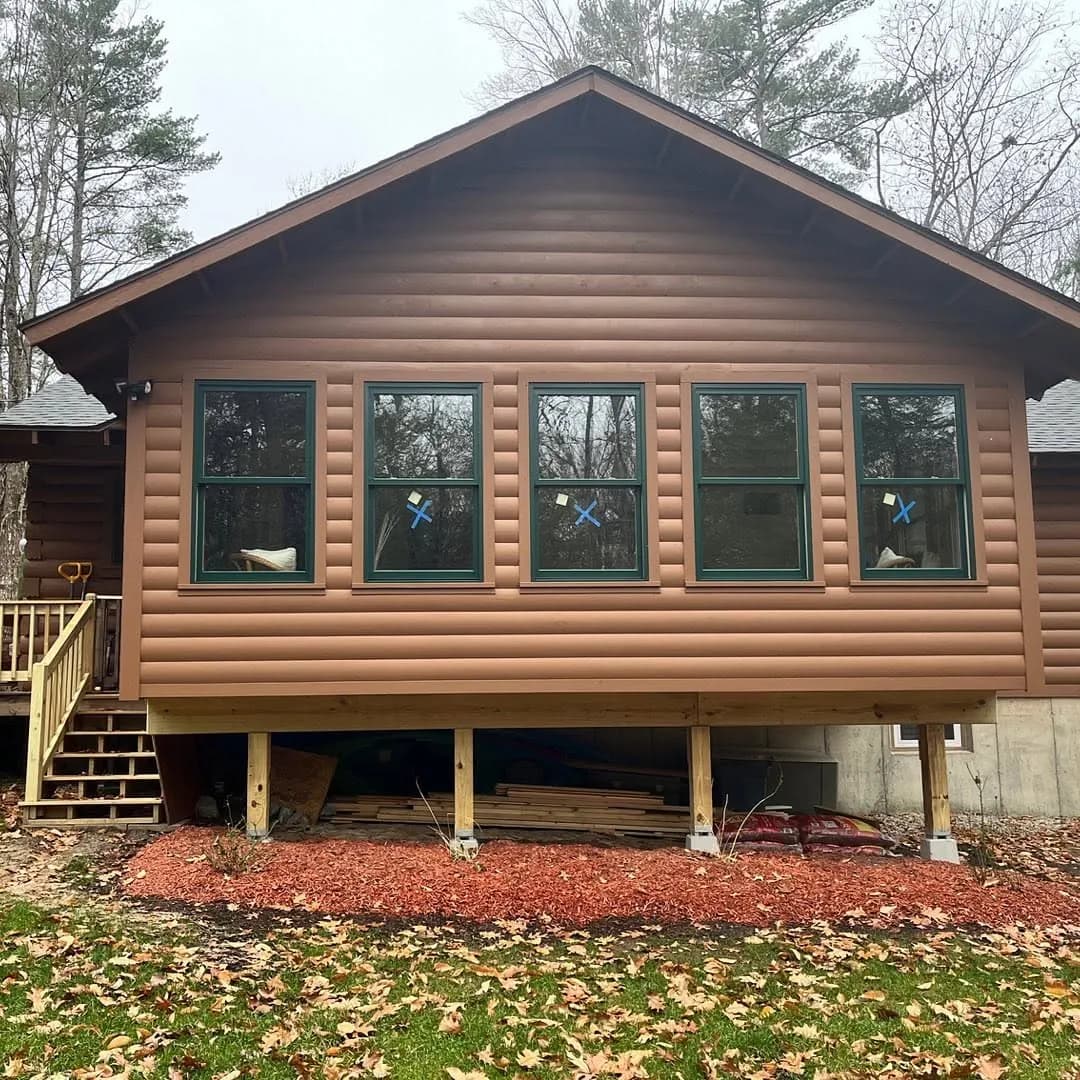 Log-profile siding on a cabin addition — Siding project in Lakes Region, NH by A&E Home Improvement