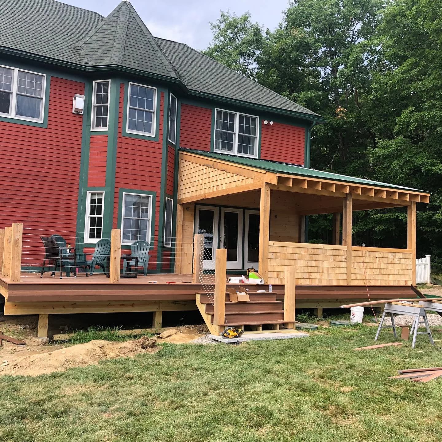 Red home with deck — Siding project in Central NH by A&E Home Improvement