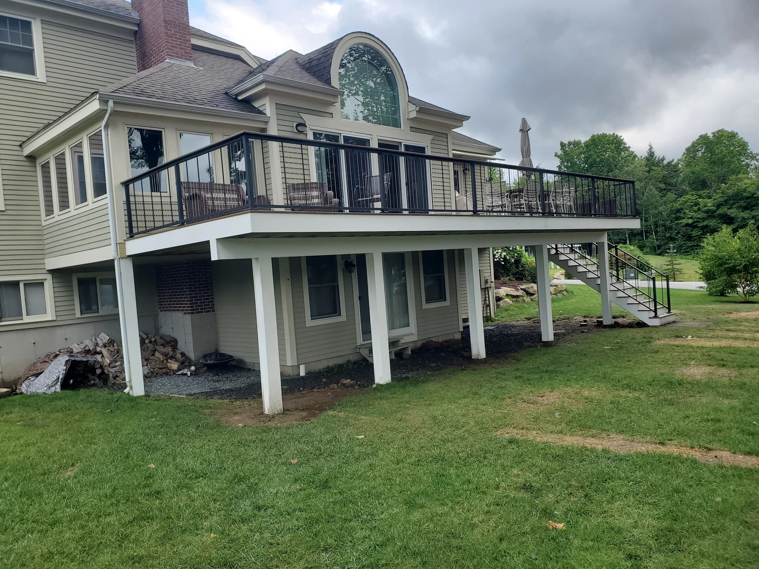 Elevated composite deck with cable railing — Decks project in Lakes Region, NH by A&E Home Improvement