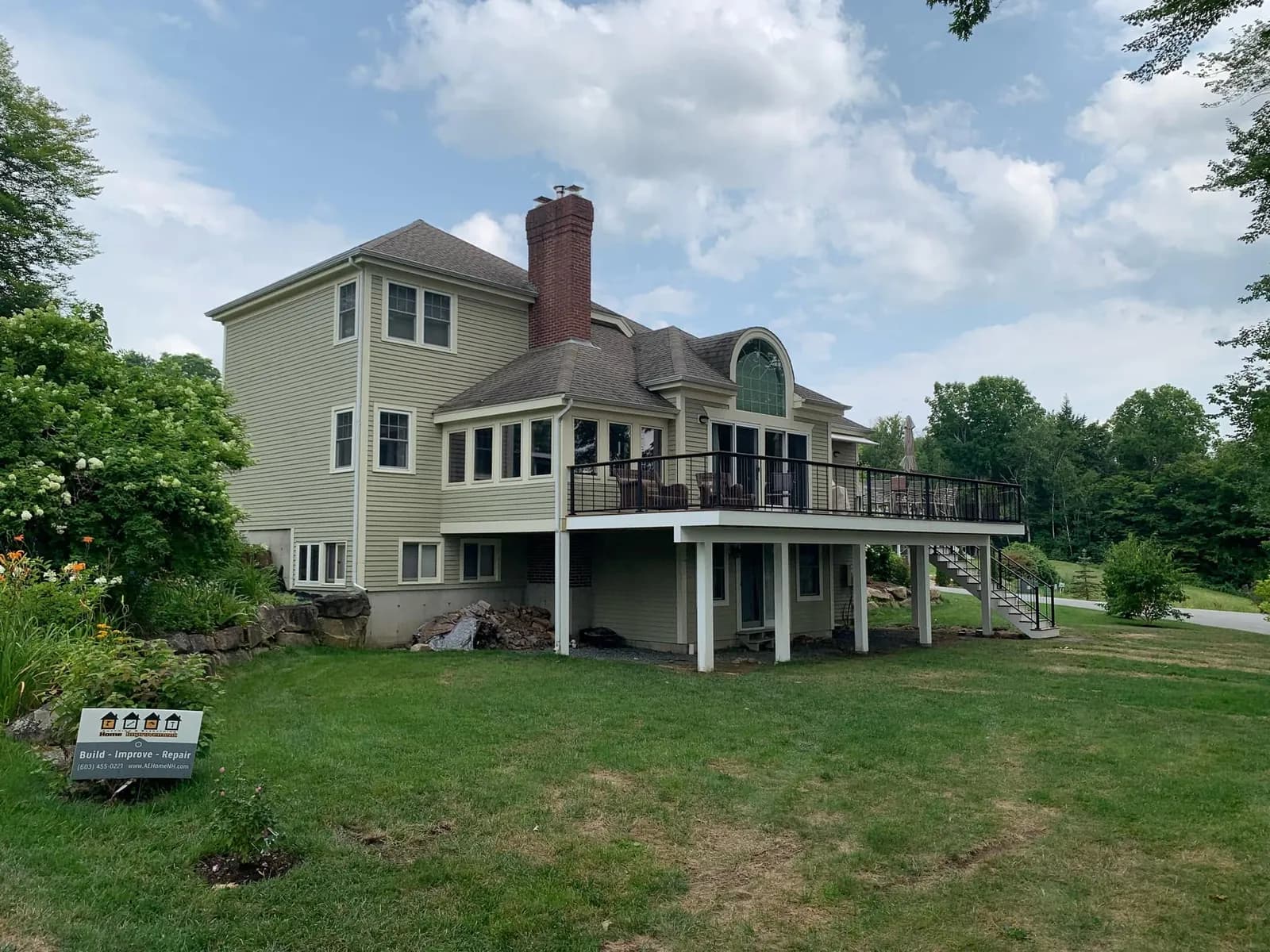 Elevated lake-house deck with black railing — Decks project in Lakes Region, NH by A&E Home Improvement