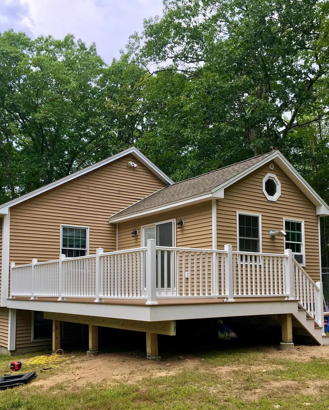 Raised deck with white railing and stairs — Decks project in Central NH by A&E Home Improvement