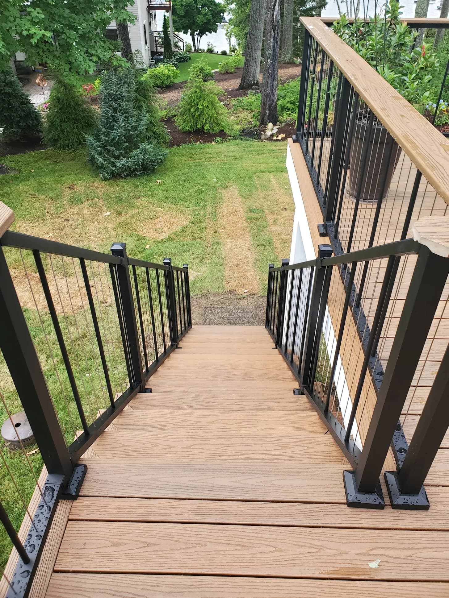 Deck stairs with metal railing — Decks project in Central NH by A&E Home Improvement