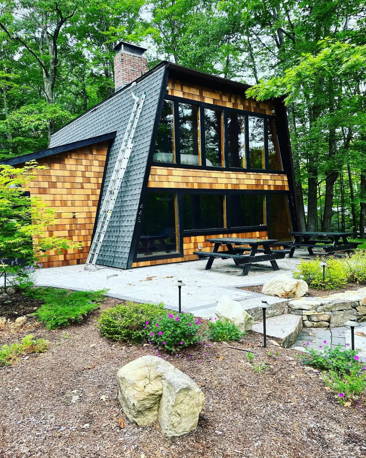 Modern home with floor-to-ceiling windows — Design/Build project in Lakes Region, NH by A&E Home Improvement