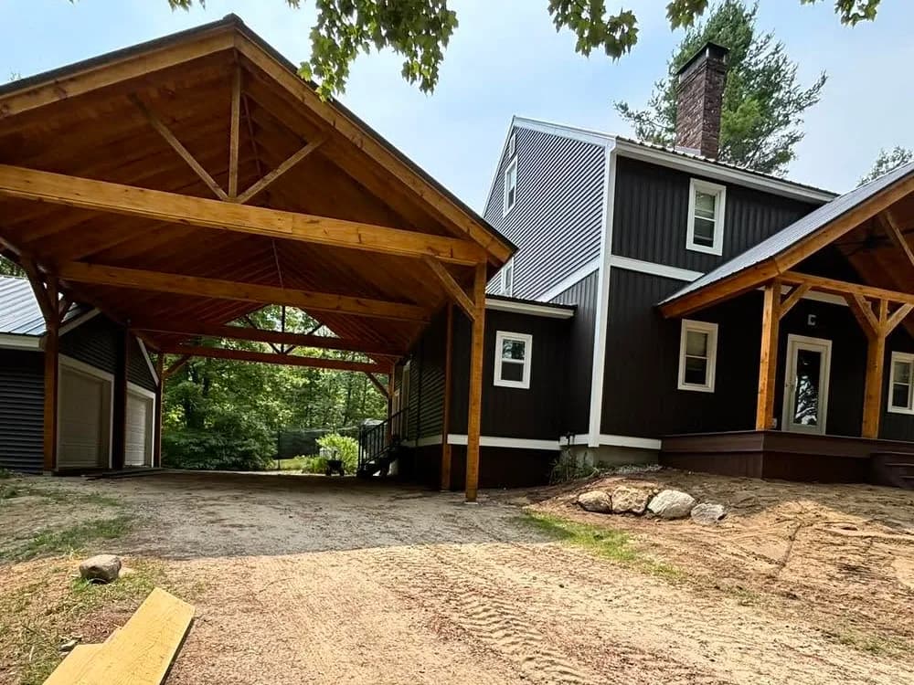 Black board-and-batten and Monogram exterior — Siding project in Campton, NH by A&E Home Improvement