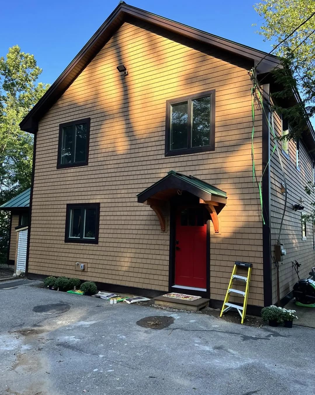 Shingle siding with a red front door — Siding project in Central NH by A&E Home Improvement