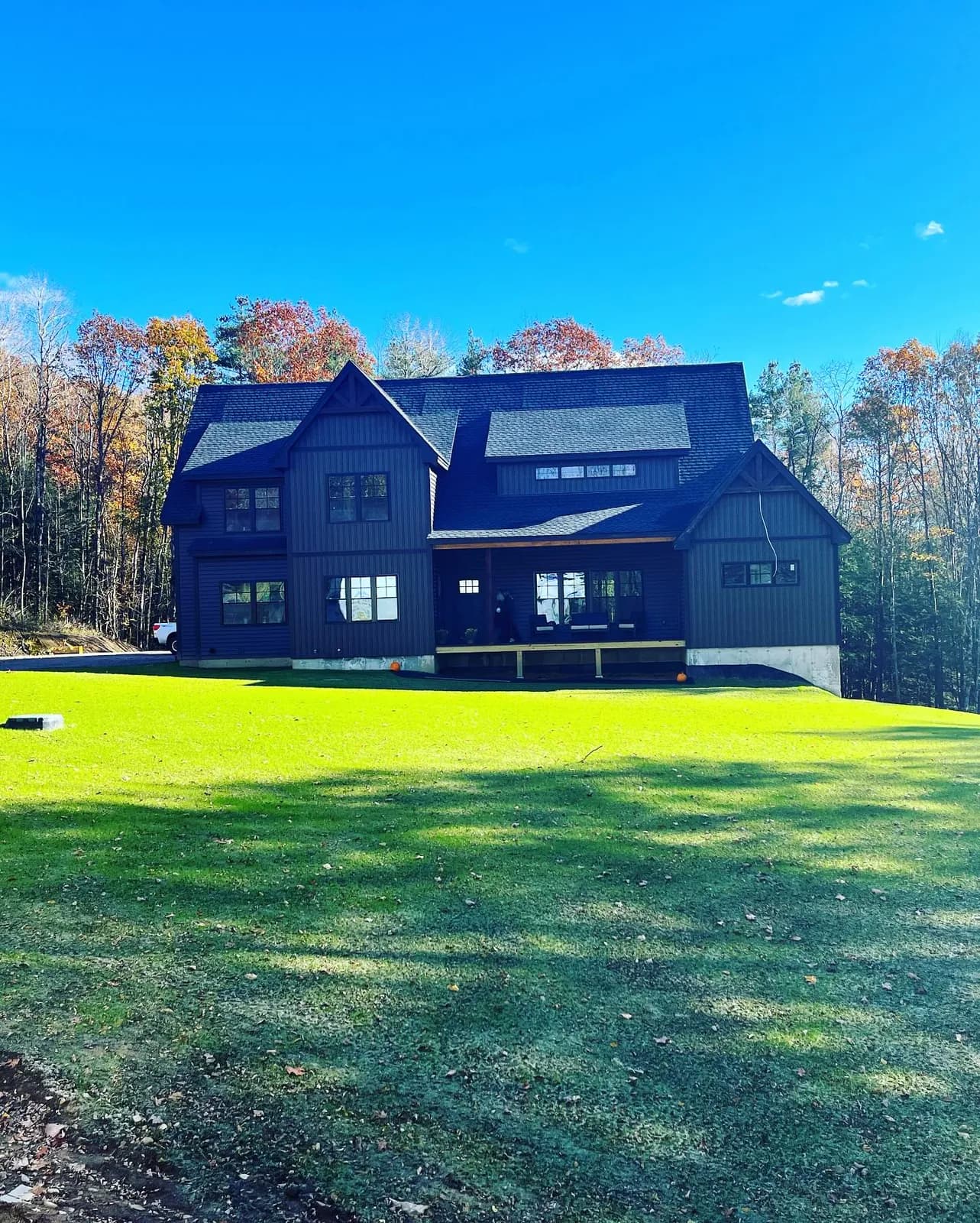Dark siding and new roof on a two-story home — Siding project in Central NH by A&E Home Improvement