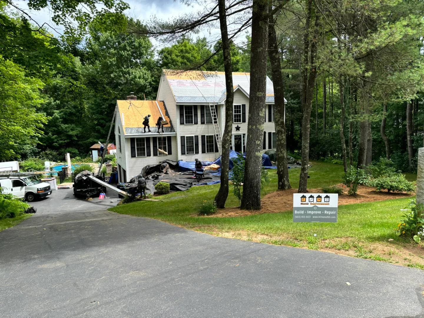 Roof replacement in progress on a white colonial — Roofing project in Southern NH by A&E Home Improvement